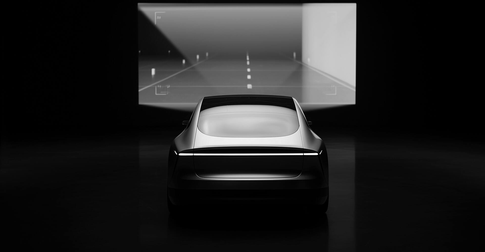 Vehicle in front of a screen with a roadway